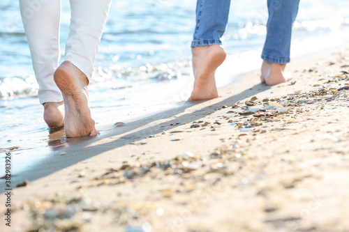 Barefoot young couple on sea beach © Pixel-Shot