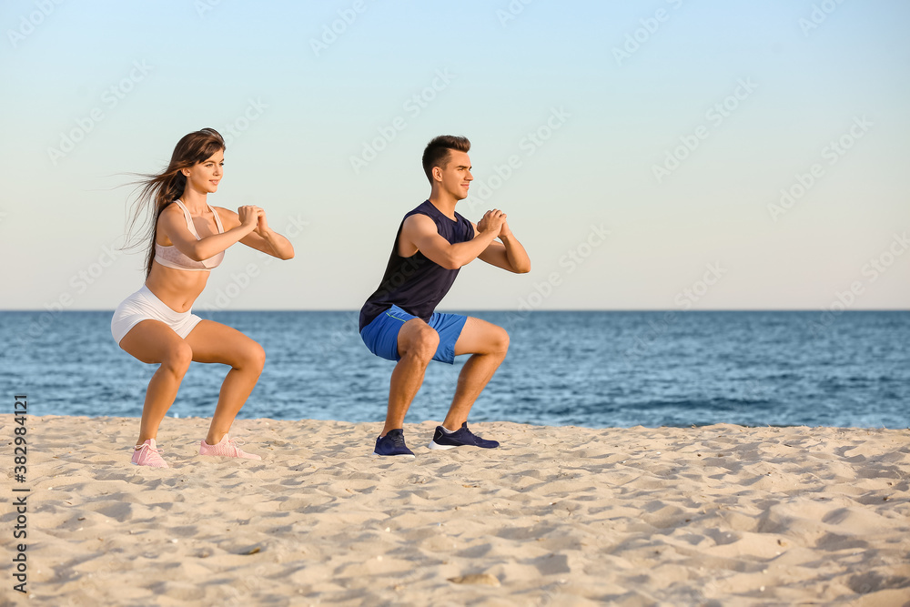 Sporty young couple training on sea beach Sporty young couple training on sea beach