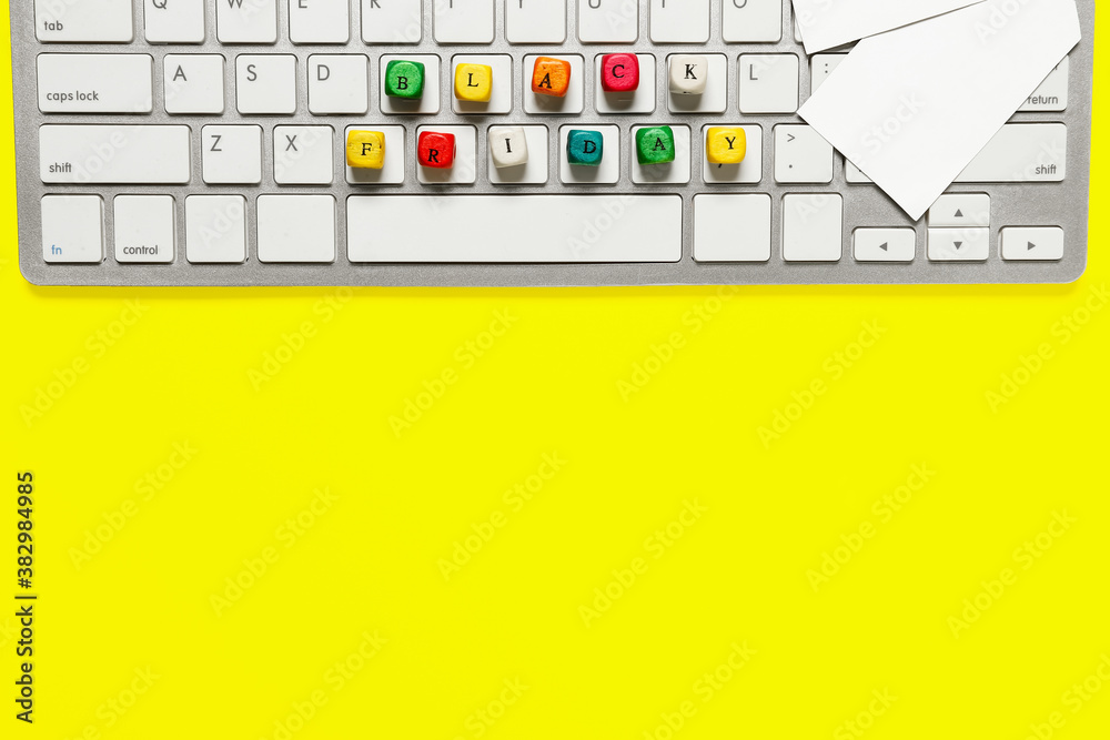 Computer keyboard with text BLACK FRIDAY on color background