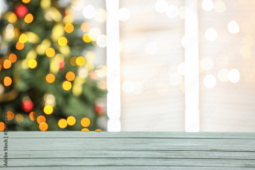 Empty wooden table against blurred Christmas lights