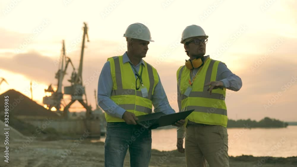 Engineers are talking at the shore of a quarry