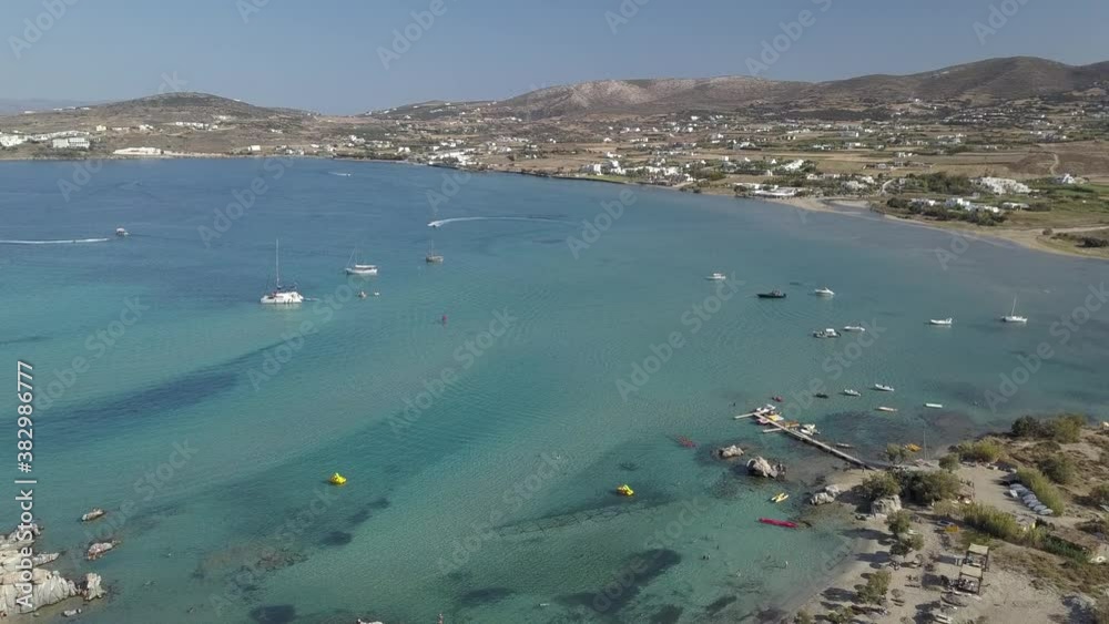 Aerial drone video of sandy beach blue sea water, clear blue sky Paros island Cyclades, Greece Aerial drone video of sandy beach blue sea water, clear blue sky Paros island Cyclades, Greece