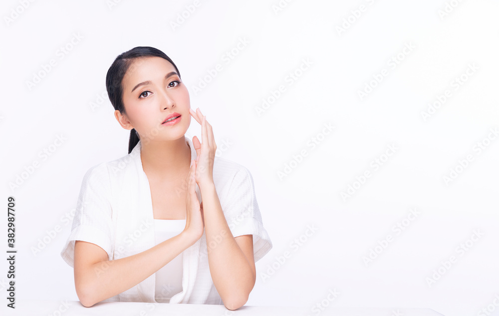Charming young woman touching her face with clean fresh skin. Teenager with perfect skin over isolated white background. Beauty cosmetics and healthy concept. Charming young woman touching her face with clean fresh skin. Teenager with perfect skin over isolated white background. Beauty cosmetics and healthy concept.