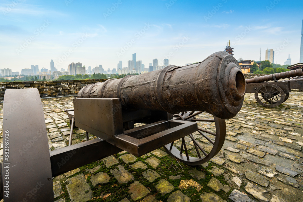 The ancient cannon is on the wall