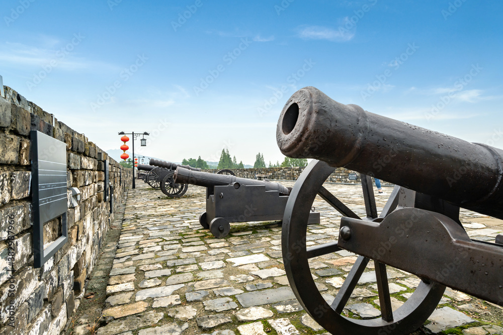 The ancient cannon is on the wall