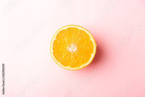Top view of Fresh half orange fruit slice in the studio shot isolated on pink background, Healthy food concept