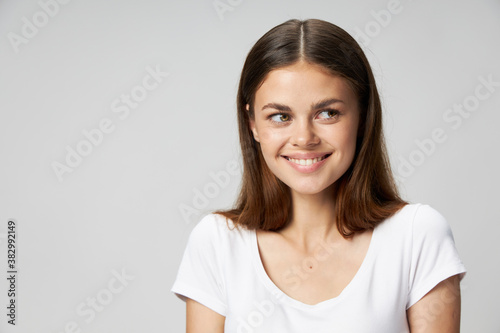 Cheerful woman looks to the side smile white T-shirt 