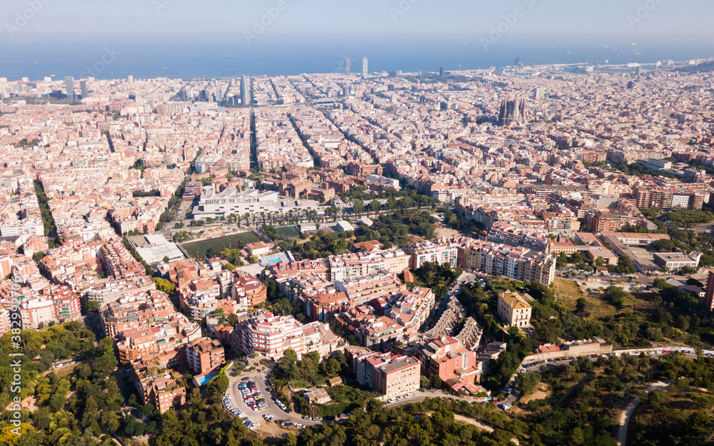 Aerial view of cityscape of Barcelona, Eixample district and Mediterranean coastline