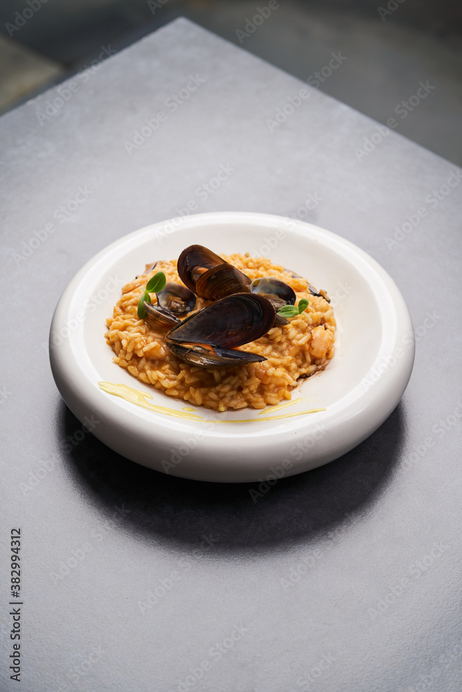 Risotto with mussels and rice in a white plate. Spanish cuisine, Seafood Paella