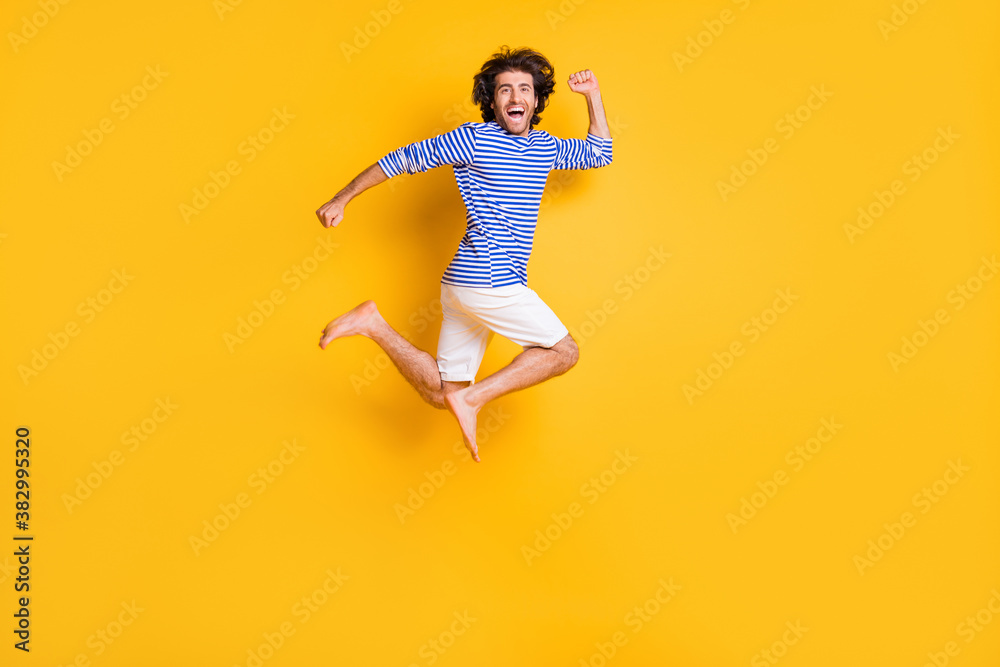 Full size profile side photo of crazy middle eastern guy jump run fast isolated over bright yellow color background