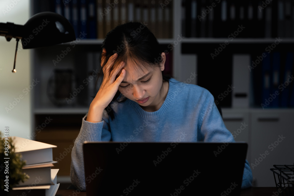 Asian business woman suffers from headache from working with computers for a long time. Asian business woman suffers from headache from working with computers for a long time.