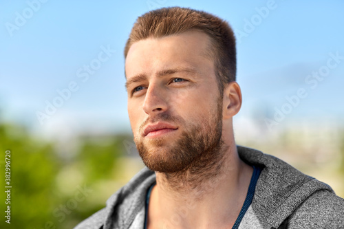 fitness, sport and people concept - portrait of young man outdoors