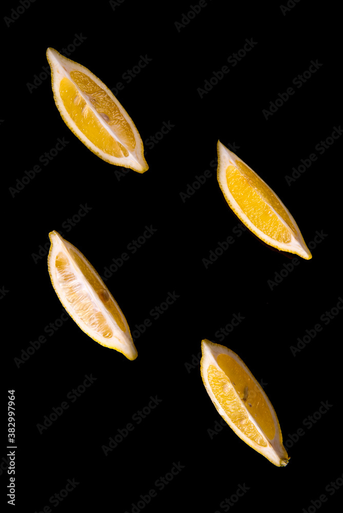 Obraz premium Lemon slices on a black background close - up