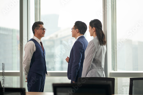 Photography asian business men and woman standing and talking in office