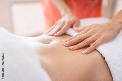 Fototapeta Naklejka Na Ścianę i Meble -  Woman have belly massage in light procedure room. Anti-cellulite massage, diastasis