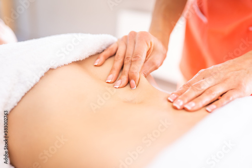 Woman have belly massage in light procedure room. Anti-cellulite massage, diastasis