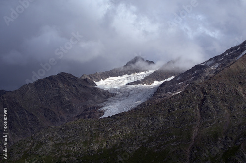 Peaks of mountains with glaciers. View of the two peaks Bolshoy Kogutai and Maly Kogutai from the slope of Mount Cheget. Terskol, Caucasus, Russia.