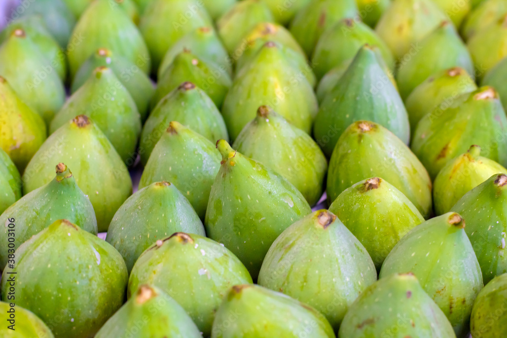 Row of vibrant green fresh ripe figs at the local market. Image with selective focus Row of vibrant green fresh ripe figs at the local market. Image with selective focus