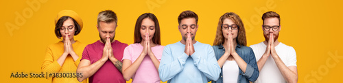 Young people praying with clasped hands