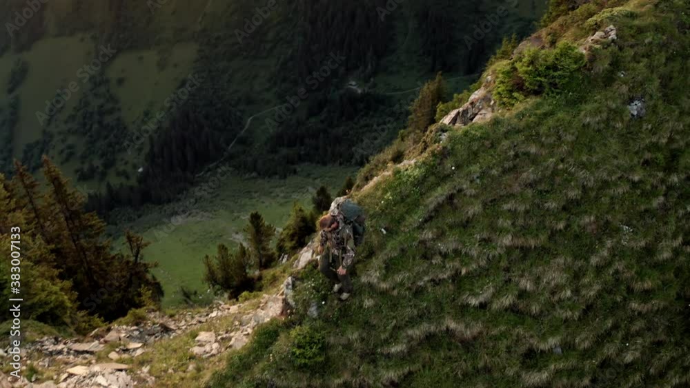 Top Down Bird Eye View of Professional Hiker Going Down the Mountain at Sunrise.