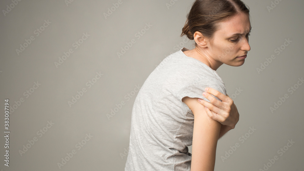 Obraz premium Tired woman feeling pain, massaging tense muscles