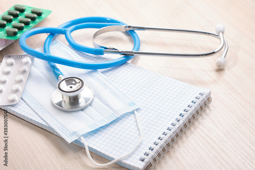 medicines, pills, medical stethoscope and notepad for notes, disease diagnosis concept medicines, pills, medical stethoscope and notepad for notes, disease diagnosis concept