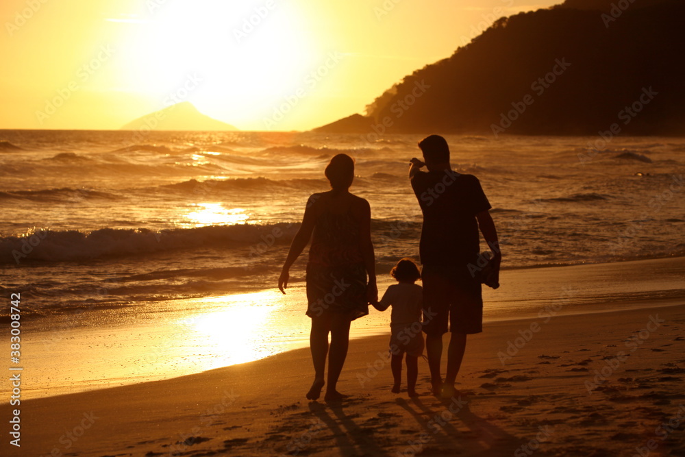 Family walking on the beach at sunset, Maresias - Brazil