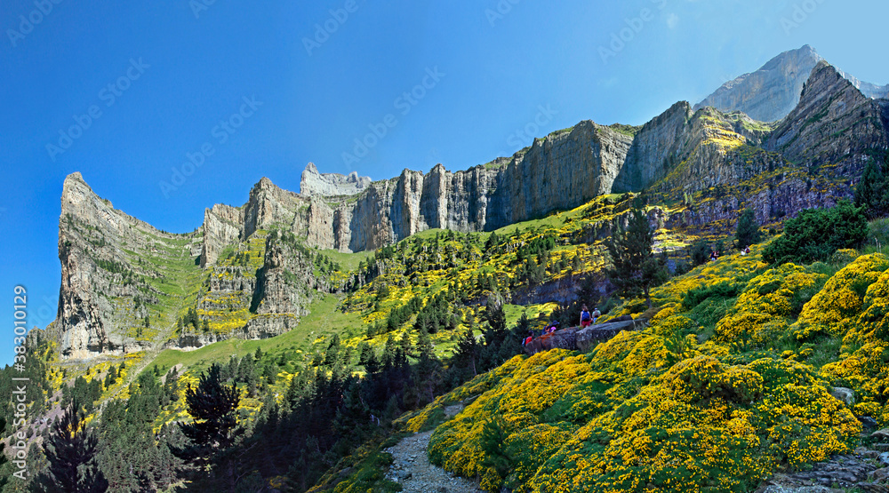 Ordesa and Monte Perdido National Park in the Spanish Pyrenees. View on the majestic Circo de Carriata, with a group of climbing hikers 
