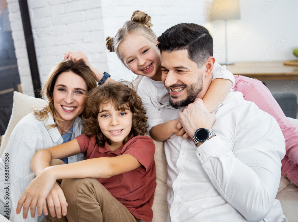 Portrait of a happy family hugging on the sofa Portrait of a happy family hugging on the sofa