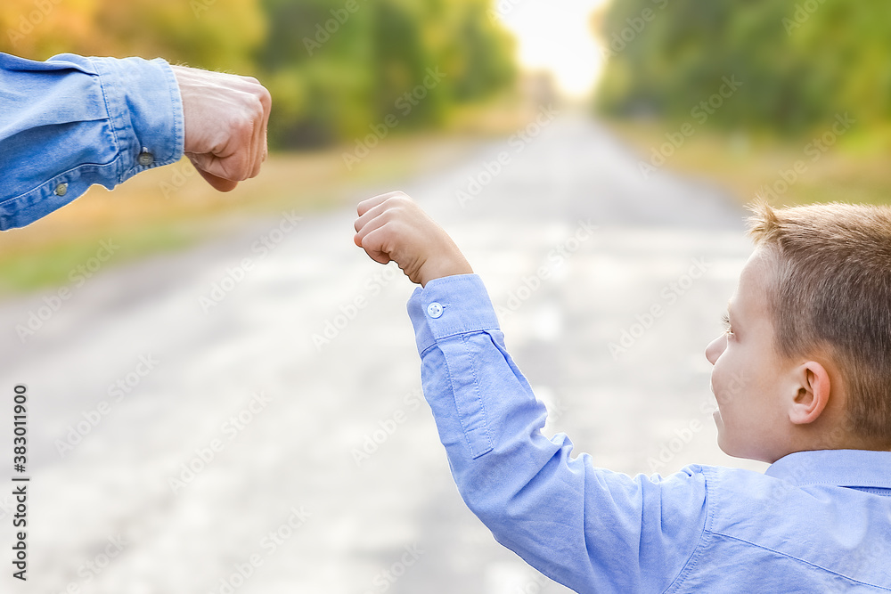 A Happy parent with a child in the park hands on nature travel go along the road A Happy parent with a child in the park hands on nature travel go along the road