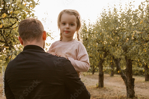 Young man holding little girl