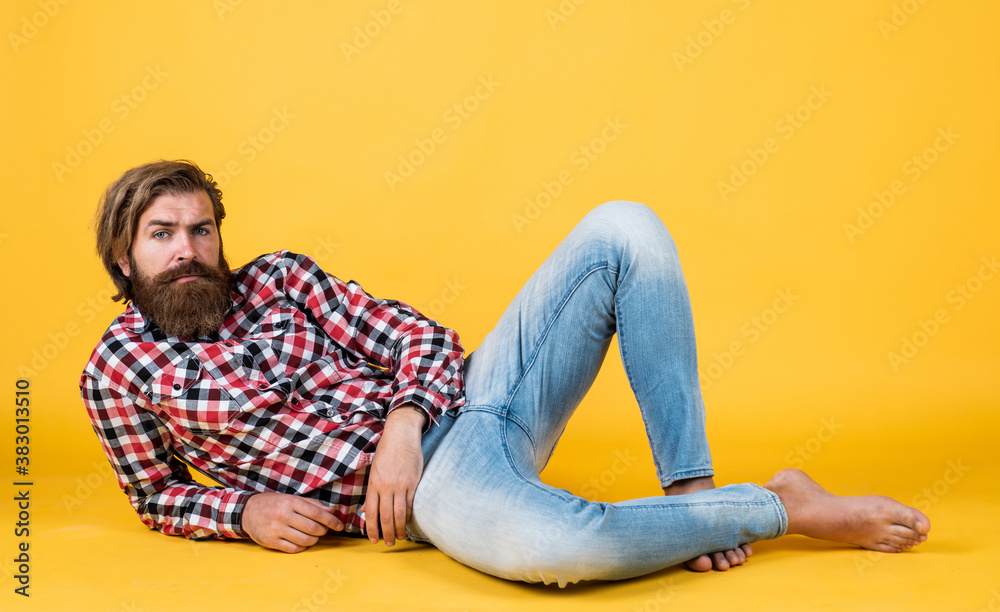looking trendy. handsome confident man has perfect hairstyle. happy bearded man in checkered shirt. male beauty concept. Portrait of bearded hipster. guy with long lush beard and mustache on face