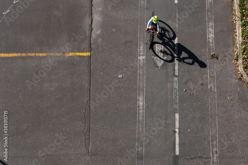 Topview on dirty asphalt road with grunge signs and bicycles with shadows