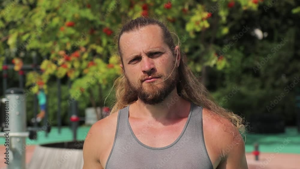 portrait of a fitness instructor with long light hair that blows by wind and beard portrait of a fitness instructor with long light hair that blows by wind and beard