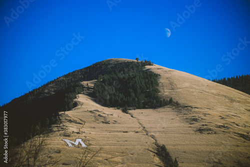 Moon with Mount Sentinel also features the hillside letter 