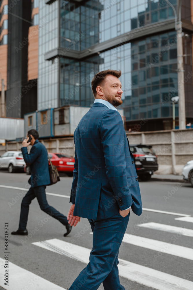 Russian businessman in a suit in the background of the city Russian businessman in a suit in the background of the city