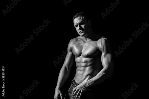 Sexy topless male model. Sexy naked torso. Sport workout bodybuilding concep. Muscular torso and chest. Isolated on black background. Black and white © Yevhen