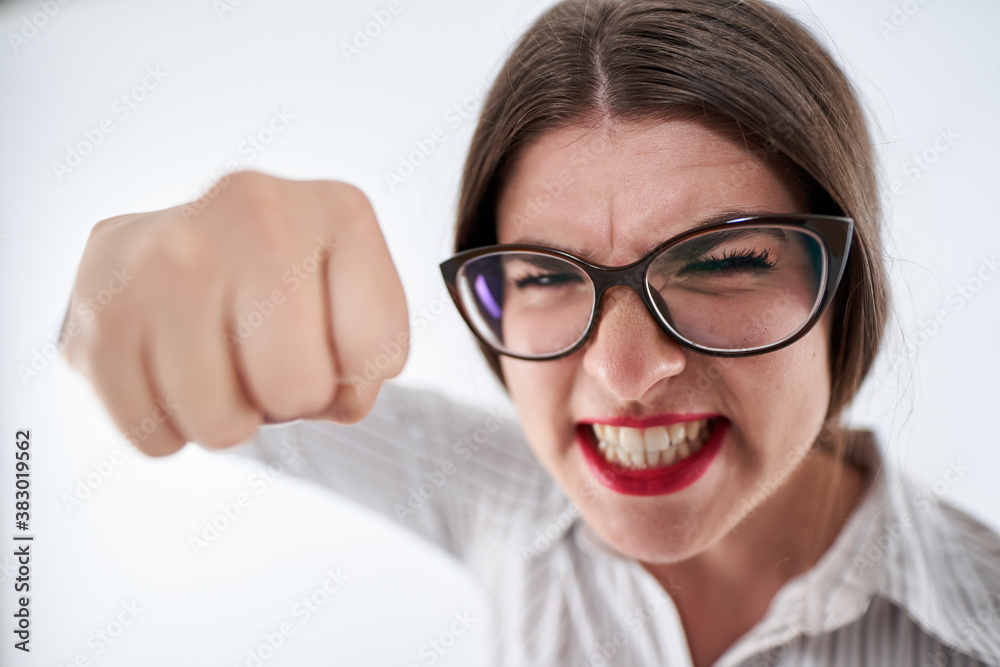 Very angry businesswoman punching towards the camera Very angry businesswoman punching towards the camera
