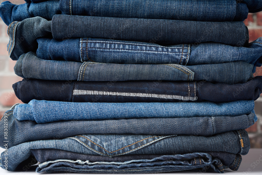 a pile of folded blue jeans different