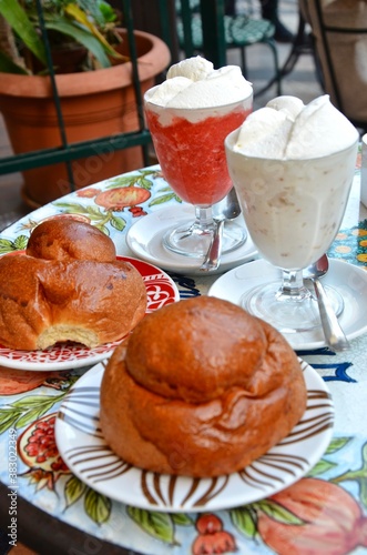 Sicilian granita with cream and brioche, on a table in an outdoor café