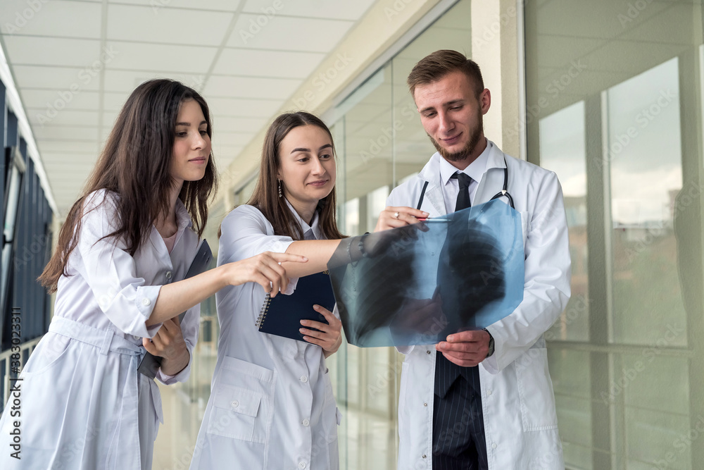 Group of doctors looking at X-ray lungs for prescribing effective treatment for new virus covid19 Group of doctors looking at X-ray lungs for prescribing effective treatment for new virus covid19