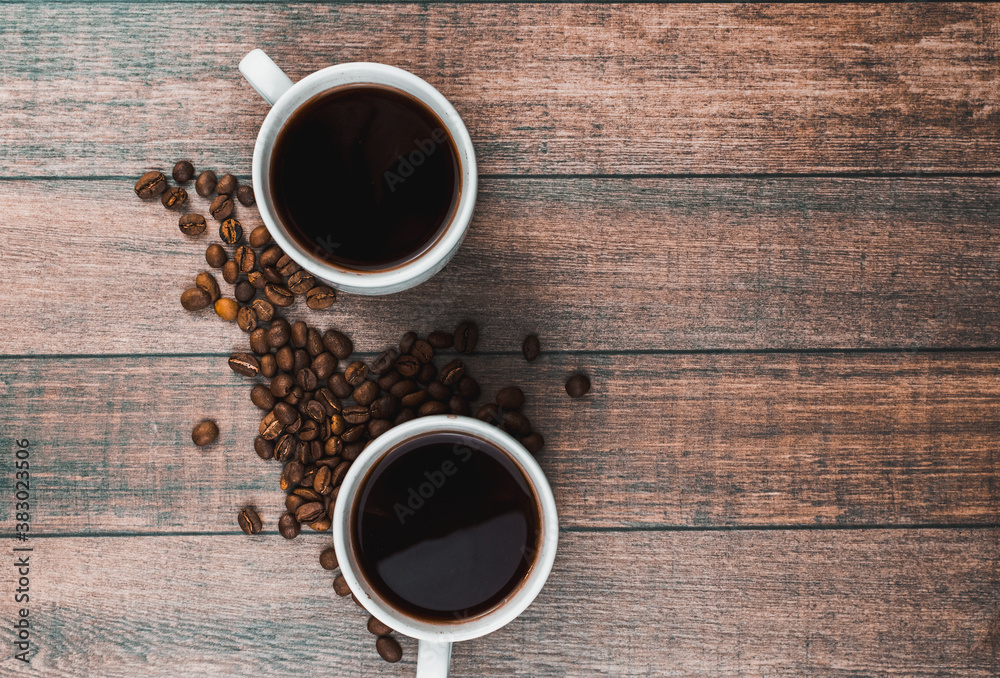 White Cup of hot coffee on a wooden table White Cup of hot coffee on a wooden table