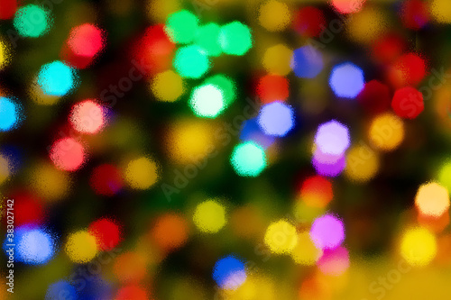 Abstract blurred disfocused Christmas lights background through wet glass
