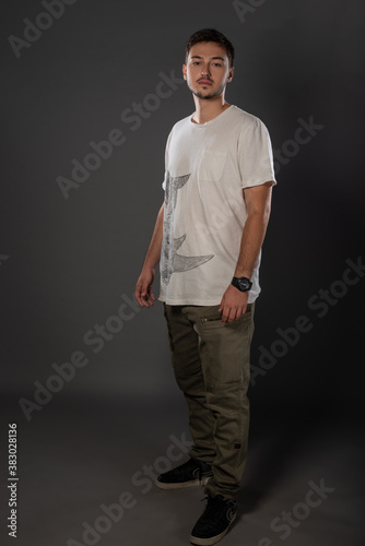 Portrait of an actor boy posing in studio on grey background. Isolated