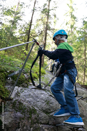 Boy using safety climbing equipment