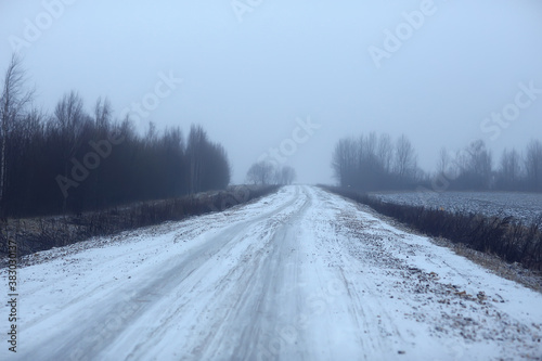 abstract winter road fog snow, landscape view in november transport