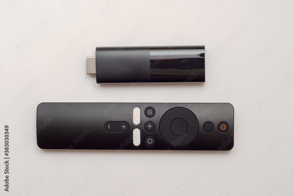 black hdmi tv box and remote control on white background black hdmi tv box and remote control on white background
