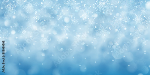 Christmas background of complex big and small falling snowflakes in light blue colors with bokeh effect © Olga Moonlight