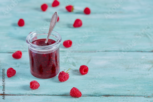 raspberry jam on wooden surface photo