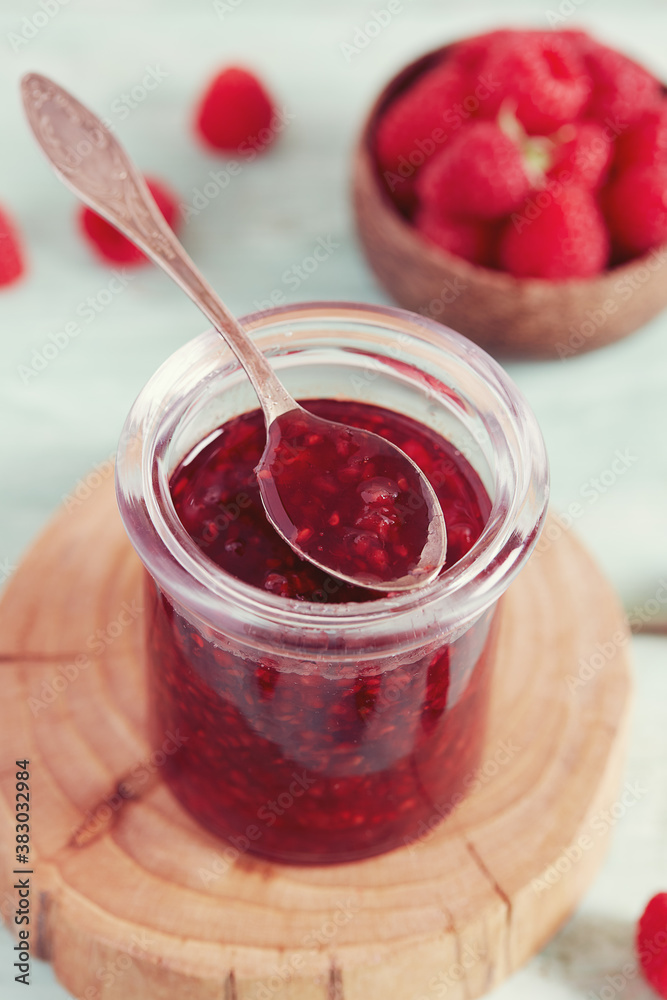 raspberry jam on wooden surface raspberry jam on wooden surface